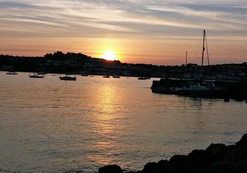 Photo Gallery Image - Sun disappearing behind Appledore (courtesy of Thom Flaxman)